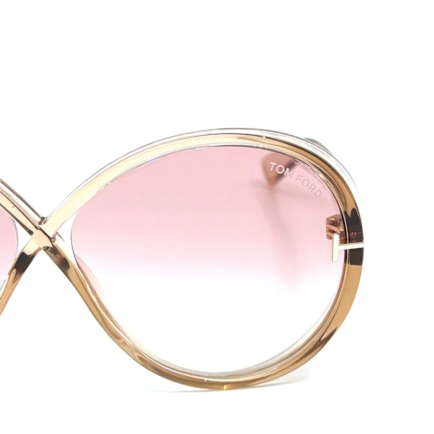Detailed view of the Tom Ford Edie-02 TF1116 45T sunglasses hinge and transparent light brown frame, highlighting premium acetate quality and 100% UV protection lenses