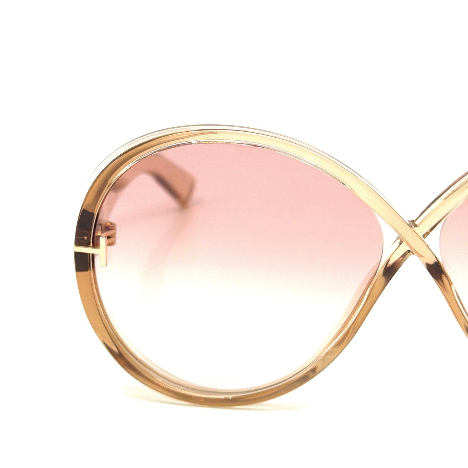 Detailed view of the Tom Ford Edie-02 TF1116 45T sunglasses hinge and transparent light brown frame, highlighting premium acetate quality and 100% UV protection lenses